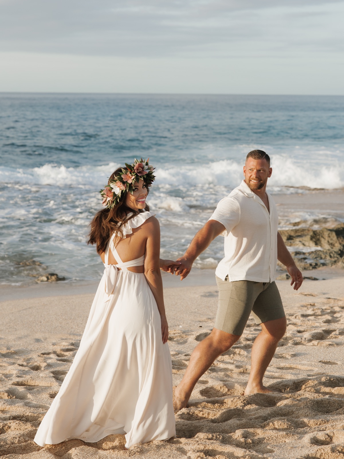Josh Littauer and his wife Morgan walking on the beach